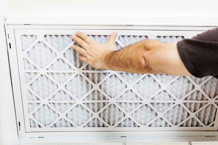Replacing a central air conditioner filter